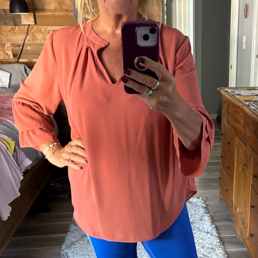 Women's Coral Blouse with tiered sleeves.
